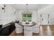 Elegant dining room with a round table, stylish chairs, modern lighting, and view to the back yard at 545 Morrison Farm Rd, Troutman, NC 28166