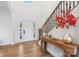 Bright foyer with hardwood floors, a staircase with iron railings, and a view of the front door at 545 Morrison Farm Rd, Troutman, NC 28166