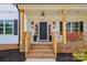 Inviting front porch with brick accents, stylish lighting, and a glimpse of the home's address at 545 Morrison Farm Rd, Troutman, NC 28166