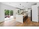 Bright, modern kitchen features a quartz island with seating and sliding doors to the deck at 545 Morrison Farm Rd, Troutman, NC 28166
