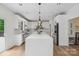 Bright kitchen features quartz countertops, stainless steel appliances, and an oversized island at 545 Morrison Farm Rd, Troutman, NC 28166