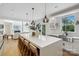 Open kitchen showcases a large island with seating, quartz countertops, and stainless steel sink at 545 Morrison Farm Rd, Troutman, NC 28166