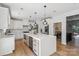 Modern kitchen with a large island, quartz countertop, stainless steel appliances, and a wine fridge at 545 Morrison Farm Rd, Troutman, NC 28166