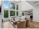 Spacious living room featuring large windows, high ceilings, modern decor, and a view into the kitchen at 545 Morrison Farm Rd, Troutman, NC 28166