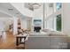 Open-concept living room featuring a fireplace, large windows, and a view of the second-floor landing at 545 Morrison Farm Rd, Troutman, NC 28166