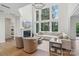 Bright and airy living room with floor-to-ceiling windows, a fireplace, and sophisticated decor at 545 Morrison Farm Rd, Troutman, NC 28166