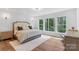 Inviting bedroom with large windows offering a picturesque view and a plush area rug at 545 Morrison Farm Rd, Troutman, NC 28166