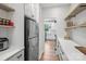 Walk-in pantry features custom shelving, quartz countertops, and a stainless steel refrigerator at 545 Morrison Farm Rd, Troutman, NC 28166