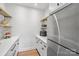 Walk-in pantry with custom shelving, quartz counters, and stainless steel refrigerator at 545 Morrison Farm Rd, Troutman, NC 28166
