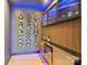 The unique wine cellar features wood paneling, custom shelving, and blue LED lighting at 545 Morrison Farm Rd, Troutman, NC 28166