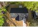 Birds-eye view of a home with a new roof, surrounded by lush greenery and a concrete driveway at 551 Belfast Dr, Gastonia, NC 28052