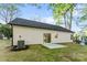 A serene home exterior with siding, a small patio, and an AC unit set against a green lawn at 551 Belfast Dr, Gastonia, NC 28052