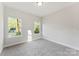 Bedroom with carpet floors and two windows that provide ample natural light at 551 Belfast Dr, Gastonia, NC 28052