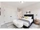 Cozy bedroom with a black upholstered headboard, and minimalist decor, bathed in natural light, showcasing a modern aesthetic at 551 Belfast Dr, Gastonia, NC 28052