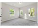This bedroom is well-lit by three windows and has carpeted floors at 551 Belfast Dr, Gastonia, NC 28052