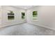 Cozy bedroom with three windows for natural light and soft gray carpeting for added comfort at 551 Belfast Dr, Gastonia, NC 28052