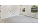 Comfortable bedroom featuring soft gray carpeting, a closet, and ample natural light from multiple windows at 551 Belfast Dr, Gastonia, NC 28052