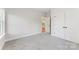 Carpeted bedroom has an open doorway and a closet with double doors at 551 Belfast Dr, Gastonia, NC 28052