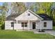 Charming single-story home with white siding, black door, and a well-manicured front lawn at 551 Belfast Dr, Gastonia, NC 28052