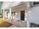 An inviting home exterior with white pillars, a sleek black front door, and modern design elements at 551 Belfast Dr, Gastonia, NC 28052
