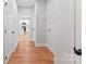 Hallway leads to an open kitchen view and features wood-look flooring and a wire storage shelf at 551 Belfast Dr, Gastonia, NC 28052