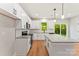 Well-equipped kitchen with granite countertops, stainless steel appliances, a kitchen island, and backyard access at 551 Belfast Dr, Gastonia, NC 28052