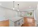 Bright kitchen island with granite countertops, hardwood floors, and views into the living area at 551 Belfast Dr, Gastonia, NC 28052