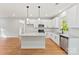 Modern kitchen featuring white cabinets, stainless steel appliances, granite countertops, and a kitchen island with pendant lighting at 551 Belfast Dr, Gastonia, NC 28052