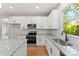 Contemporary kitchen with white cabinetry, granite counters, stainless appliances, and subway tile backsplash at 551 Belfast Dr, Gastonia, NC 28052