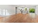 Bright, open-concept living space with hardwood floors and a modern kitchen with stainless steel appliances at 551 Belfast Dr, Gastonia, NC 28052