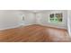 A bright and airy living room with gleaming hardwood floors and a view to the outdoors through a window at 551 Belfast Dr, Gastonia, NC 28052