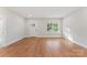 A well-lit living room with hardwood floors and a white door that provides a clean and modern look at 551 Belfast Dr, Gastonia, NC 28052
