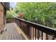 Spacious balcony with dark wooden railing, plus views of lush greenery and private garden at 5807 Sharon Rd # A, Charlotte, NC 28210