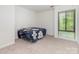 Bright bedroom featuring neutral carpet and a large window for plenty of natural light at 5807 Sharon Rd # A, Charlotte, NC 28210
