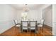 Elegant dining room featuring a chandelier, wainscoting, and direct access to the kitchen at 5807 Sharon Rd # A, Charlotte, NC 28210