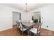 Dining room with a chandelier, wood floors, and white wainscoting for a classic look at 5807 Sharon Rd # A, Charlotte, NC 28210