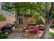Charming brick facade with unique arched window, landscaped garden, and inviting front steps leading to the main entrance at 5807 Sharon Rd # A, Charlotte, NC 28210