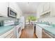 Bright kitchen featuring white cabinetry, stainless steel appliances, and a view of the outdoors at 5807 Sharon Rd # A, Charlotte, NC 28210
