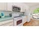 Functional kitchen featuring white appliances, ample cabinetry, and a view of the outside at 5807 Sharon Rd # A, Charlotte, NC 28210