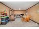 Bright living room offers a comfy couch, armchair, dinette set, and toys for flexible space usage at 5807 Sharon Rd # A, Charlotte, NC 28210