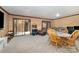 Comfortable living room features sliding glass door and wood-style accent wall, offering flexible living space at 5807 Sharon Rd # A, Charlotte, NC 28210