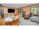 Well-lit living room includes a TV and dining table, with sliding glass doors to a private patio space at 5807 Sharon Rd # A, Charlotte, NC 28210