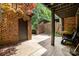 Brick patio with storage area is lined with greenery, offers a serene spot for relaxation and entertainment at 5807 Sharon Rd # A, Charlotte, NC 28210