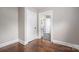 Bedroom with hardwood floors and doors to the bathroom and hall at 601 Whisnant St, Shelby, NC 28150