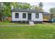 Charming home featuring a well-manicured lawn, covered parking, and a classic white exterior with black trim at 601 Whisnant St, Shelby, NC 28150