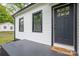 Close up of the front entrance showing the welcome mat, black door with glass panes, and fresh paint at 601 Whisnant St, Shelby, NC 28150
