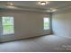Spacious bedroom with neutral carpet, tray ceiling and natural light from the double windows at 6333 Honor Ave, Midland, NC 28107