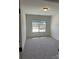 A cozy bedroom with a window overlooking the neighborhood at 6333 Honor Ave, Midland, NC 28107