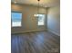 Bright dining room area with hardwood floors, chandelier, and large windows at 6333 Honor Ave, Midland, NC 28107