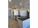 Open kitchen with a large island, black countertop, stainless steel appliances, and sleek white cabinetry at 6333 Honor Ave, Midland, NC 28107